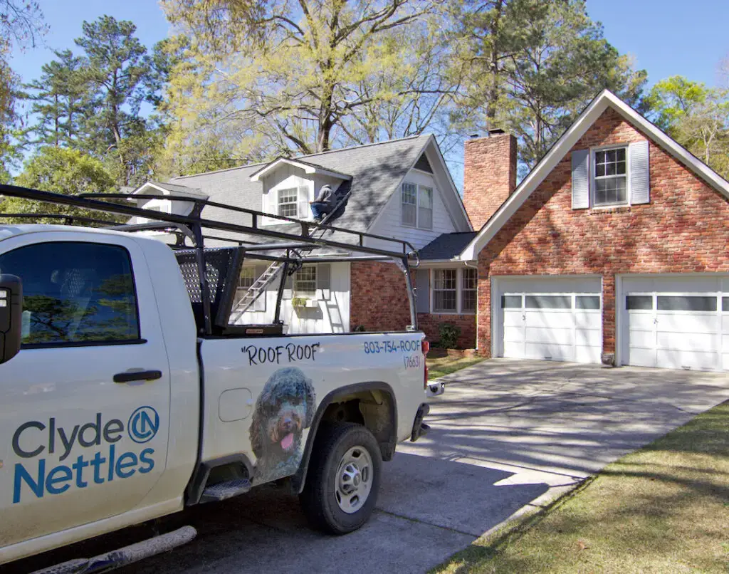 Clyde Nettles Roofing truck outside of a new roof replacement